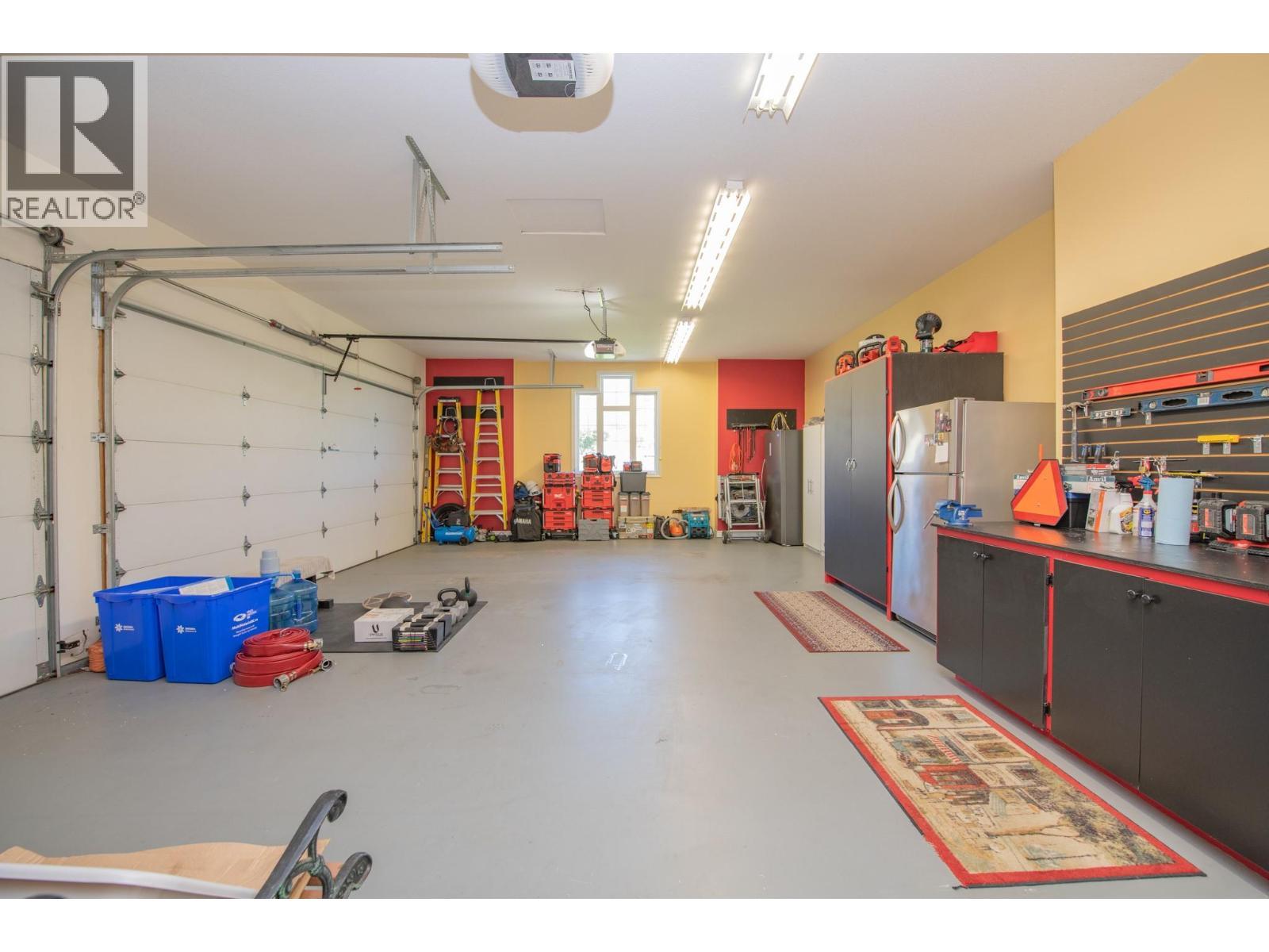 Triple heated garage - 8163 Old Kamloops Road, Vernon, BC - Indoor Photo Showing Garage