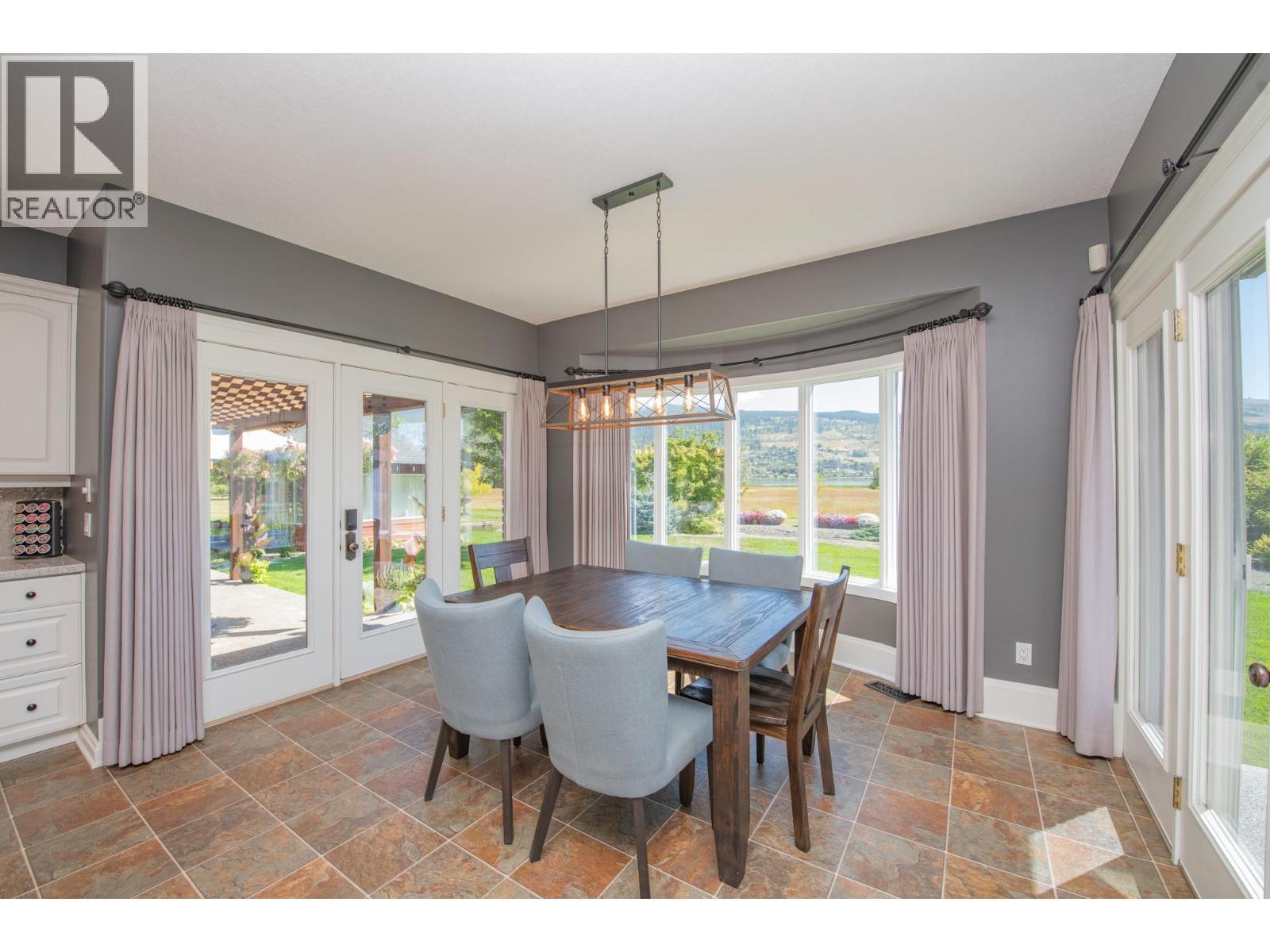 Breakfast nook leads out to back yard - 8163 Old Kamloops Road, Vernon, BC - Indoor Photo Showing Dining Room