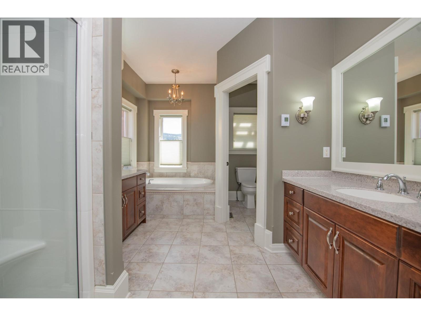 Large Ensuite with shower, bath, double vanities and water closet - 8163 Old Kamloops Road, Vernon, BC - Indoor Photo Showing Bathroom