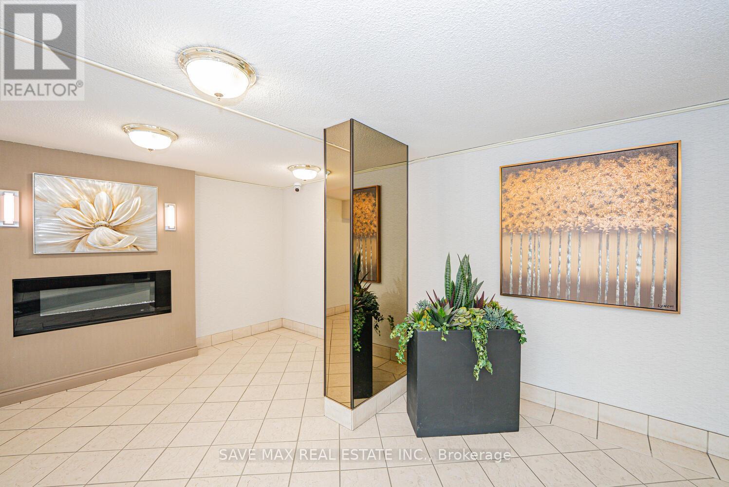 304 - 18 Knightsbridge Road, Brampton, ON - Indoor Photo Showing Other Room With Fireplace