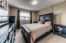 Bedroom featuring light colored carpet and a textured ceiling -