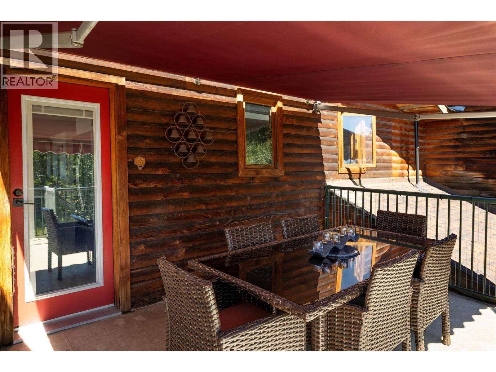 Access into Kitchen from Deck - 7940 Keddleston Road, Vernon, BC - Outdoor With Deck Patio Veranda With Exterior