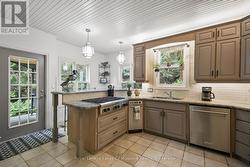 custom kitchen with access to side covered BBQ -