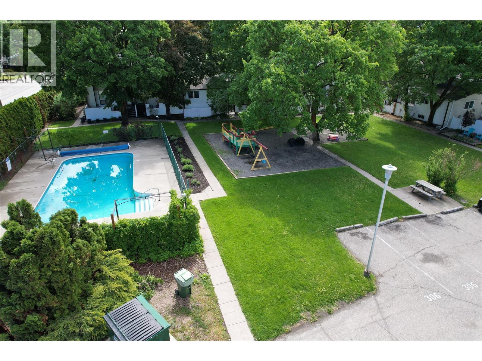 2100 43 Avenue Unit# 205, Vernon, BC - Outdoor With In Ground Pool With Backyard