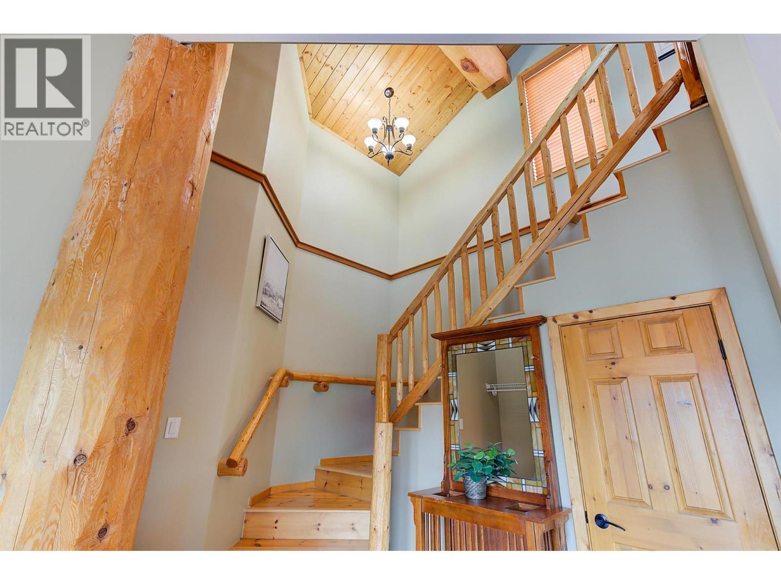 Log beam accents throughout - 7172 Brent Road, Peachland, BC - Indoor Photo Showing Other Room