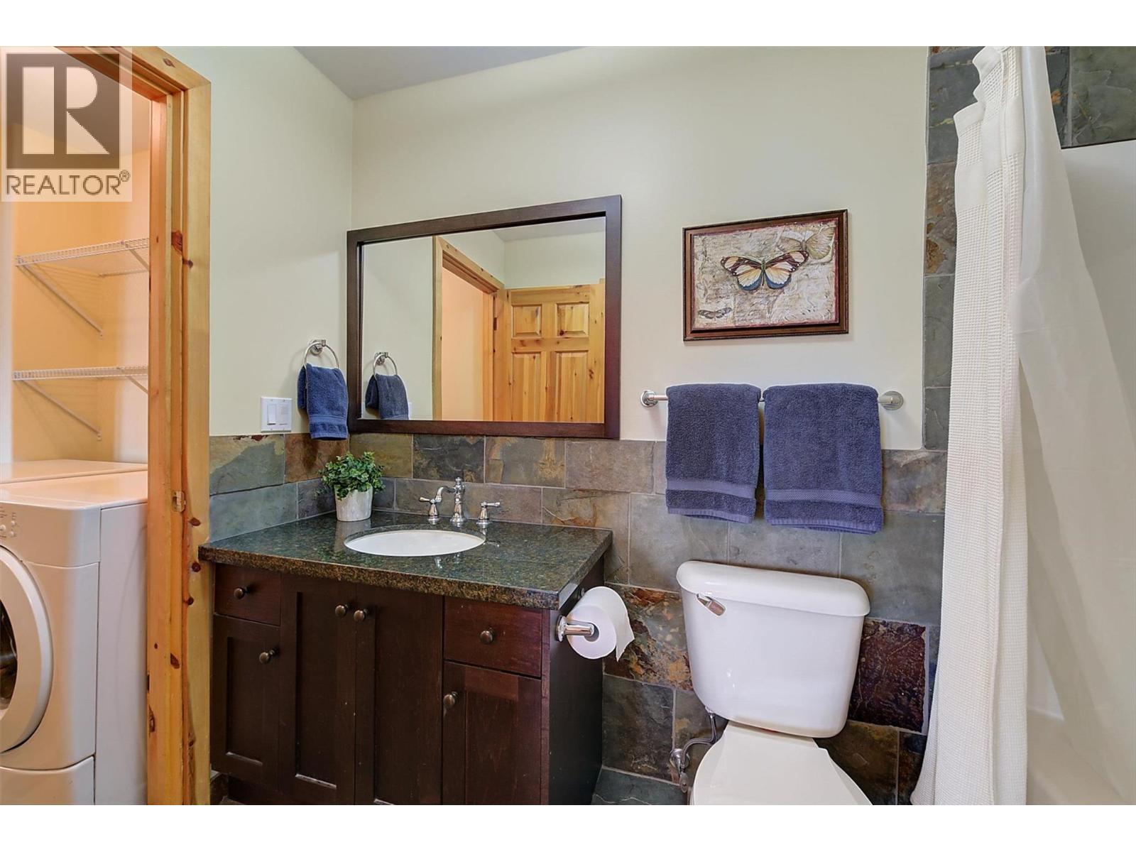 4 piece shared ensuite with access to laundry room. - 7172 Brent Road, Peachland, BC - Indoor