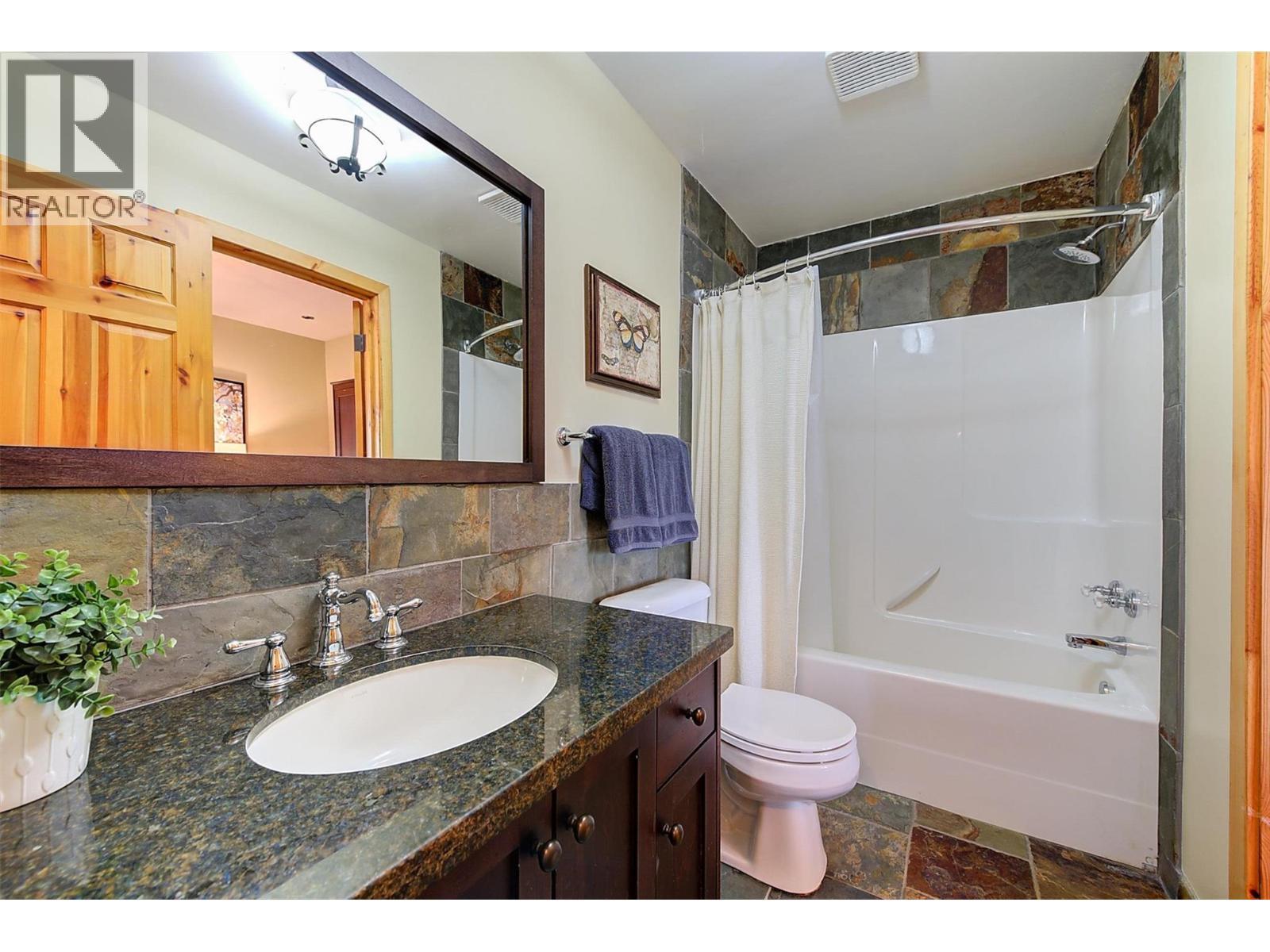 Wood cabinetry with granite counters - 7172 Brent Road, Peachland, BC - Indoor Photo Showing Bathroom