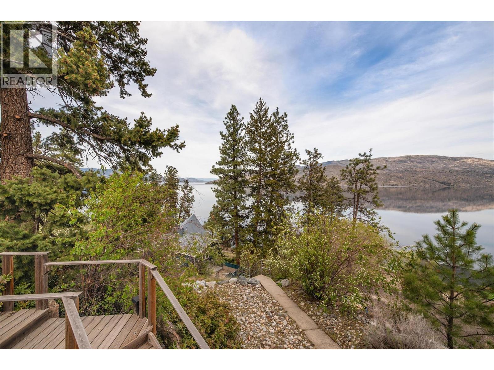 Stairs and pathway to access the waterfront and dock - 7172 Brent Road, Peachland, BC - Outdoor With Body Of Water With View