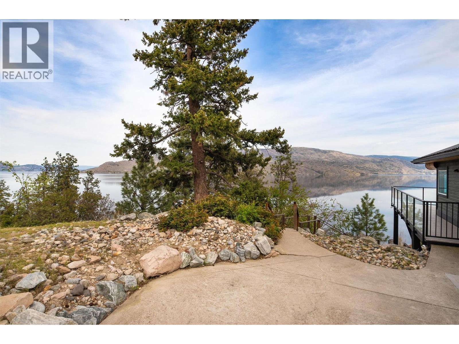 Stair and pathway access to private 80 feet of shoreline, beach and dock! - 7172 Brent Road, Peachland, BC - Outdoor With Body Of Water With View