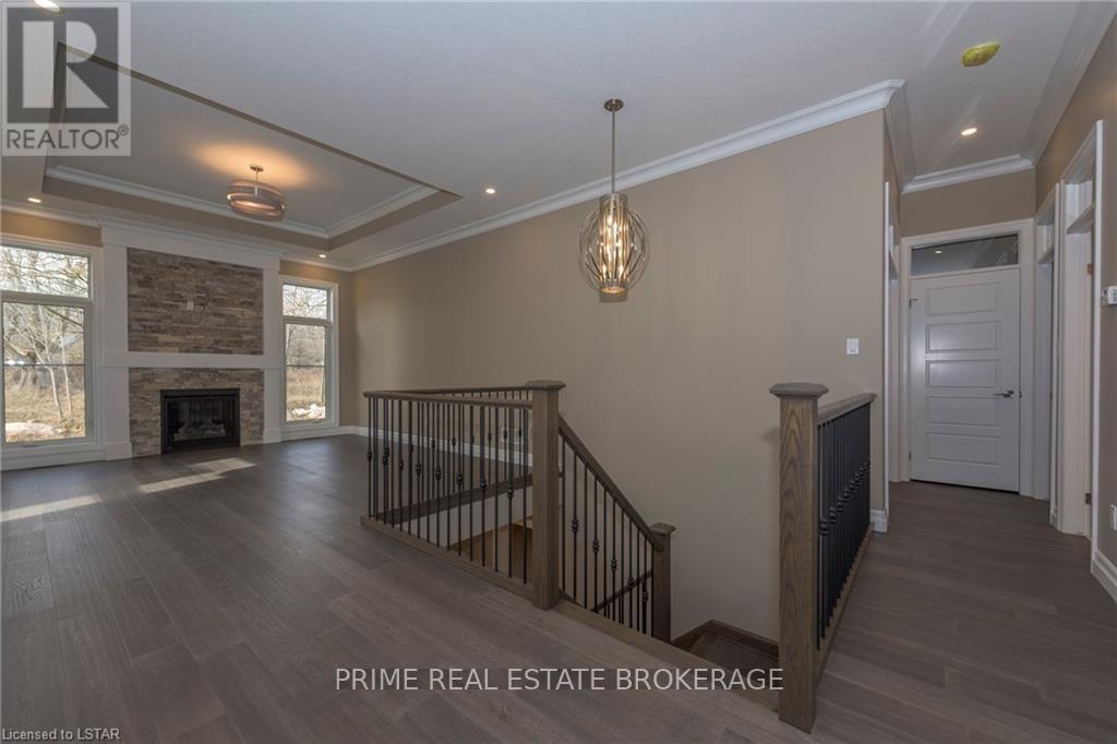 Example of staircase from model home. - 10142 Pinery Bluffs Road, Lambton Shores, ON - Indoor Photo Showing Other Room With Fireplace