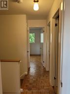 View of the hall and back bedroom. -