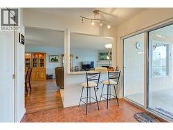 Kitchen to living room and patio doors that lead to the covered deck. -