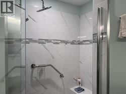 Updated tile shower with glass door. -