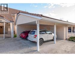 Carport parking with storage room in front of stall. -