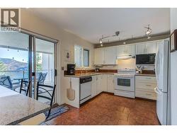 Kitchen with plenty of counter and cabinet space plus access to the private covered deck. -