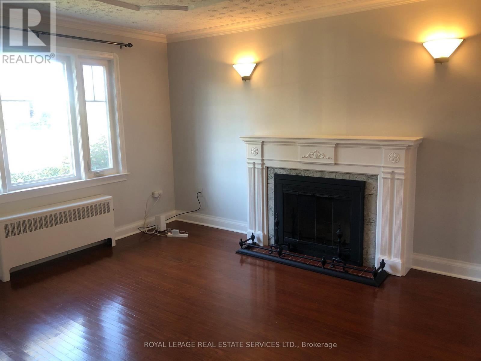 Main Fl - 1 Ash Crescent, Toronto, ON - Indoor Photo Showing Living Room With Fireplace