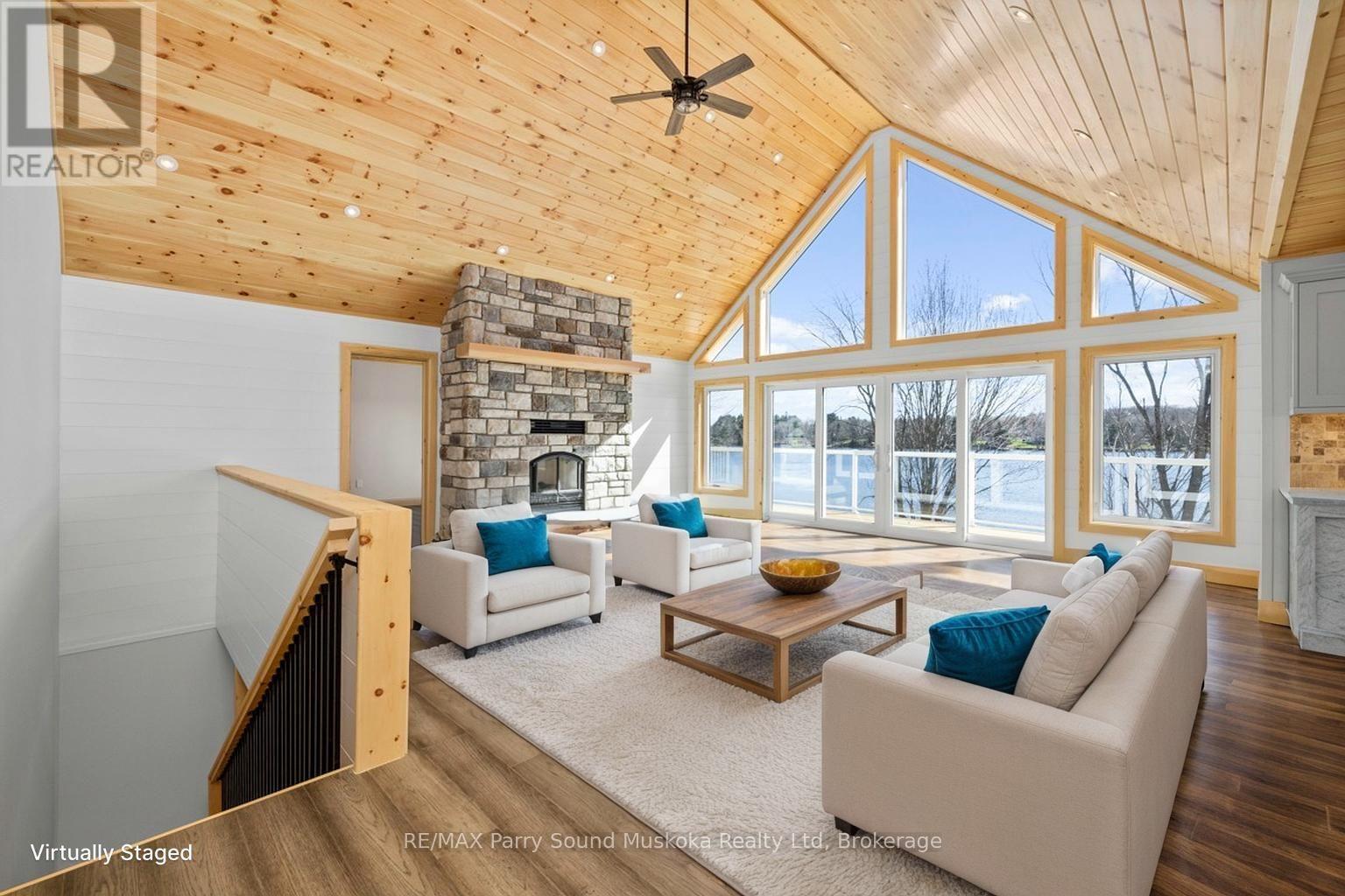 Captivating great room, virtually staged - 49 Hardies Road, Mckellar, ON - Indoor With Fireplace