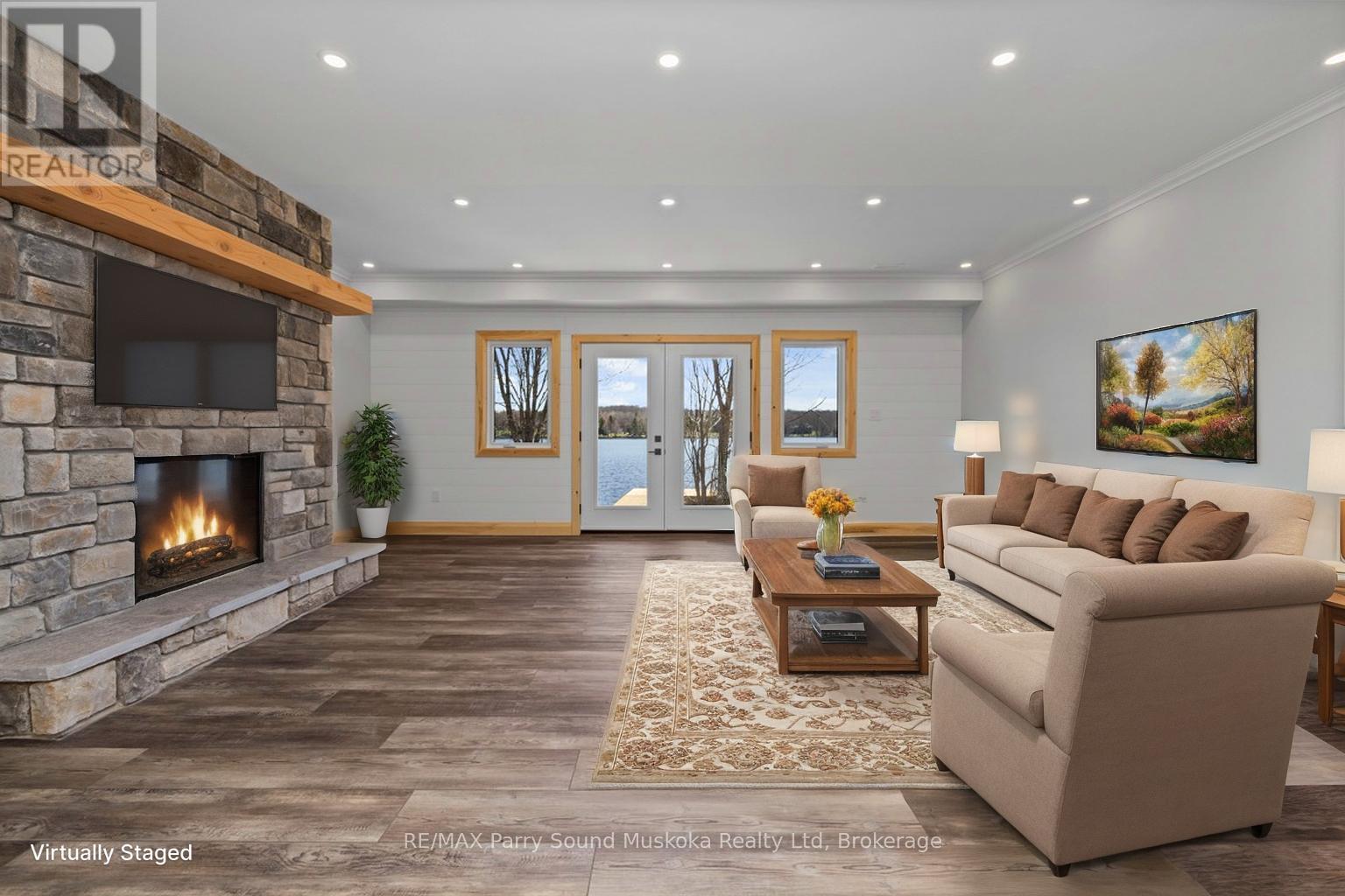 Lower level family room, virtually staged - 49 Hardies Road, Mckellar, ON - Indoor Photo Showing Living Room With Fireplace