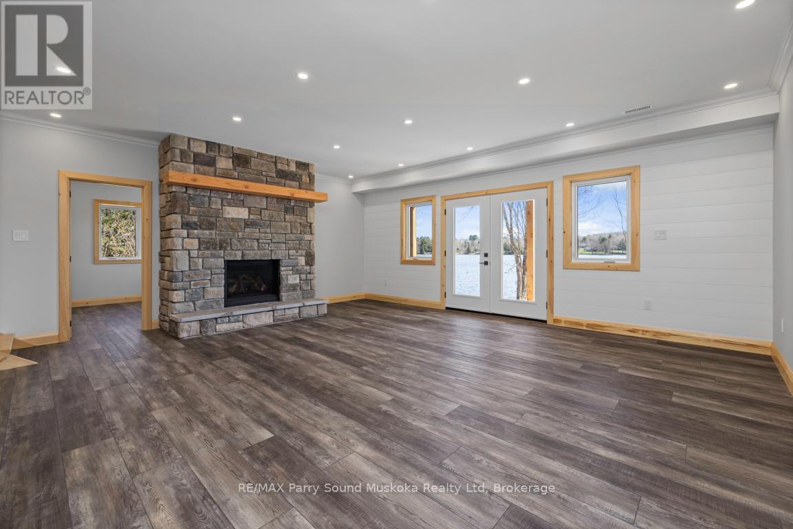 Lower level gas fireplace - 49 Hardies Road, Mckellar, ON - Indoor Photo Showing Living Room With Fireplace