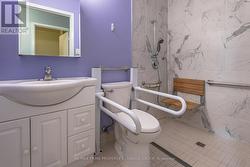 Bathroom with grab bars and curbless shower -