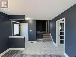 Living Room Looking at Foyer & Upper Level -
