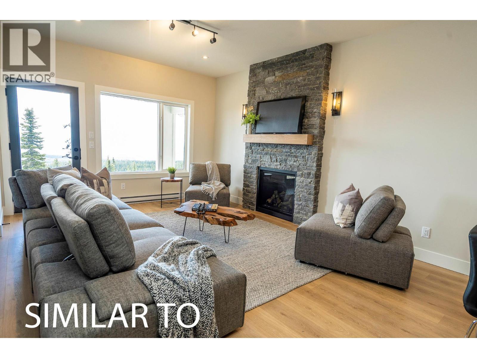 225A Grizzly Ridge Trail, Big White, BC - Indoor Photo Showing Living Room With Fireplace