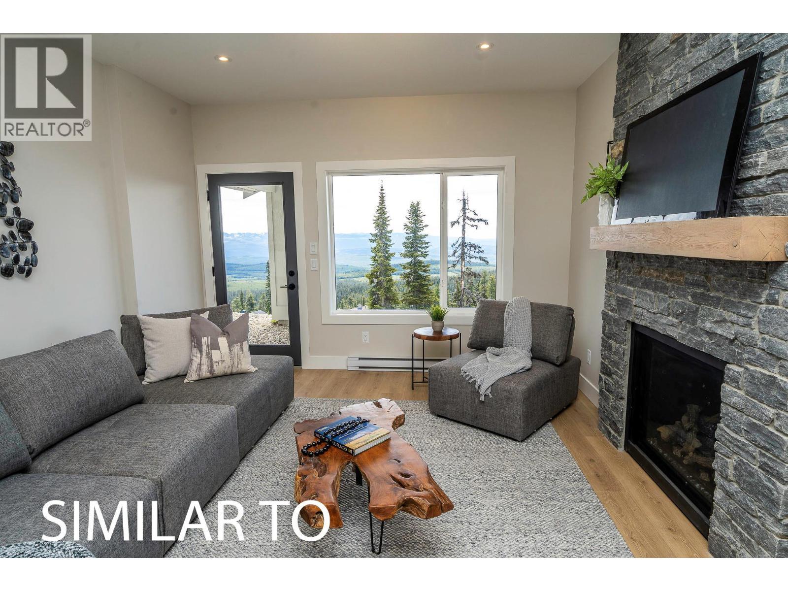 225A Grizzly Ridge Trail, Big White, BC - Indoor Photo Showing Living Room With Fireplace