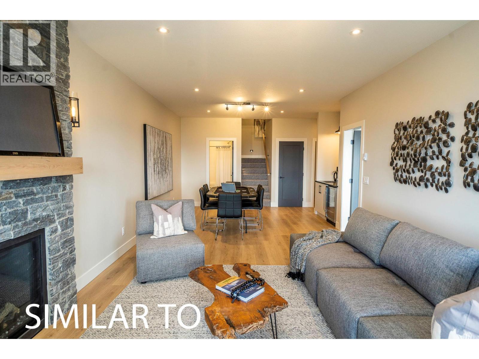 225A Grizzly Ridge Trail, Big White, BC - Indoor Photo Showing Living Room With Fireplace