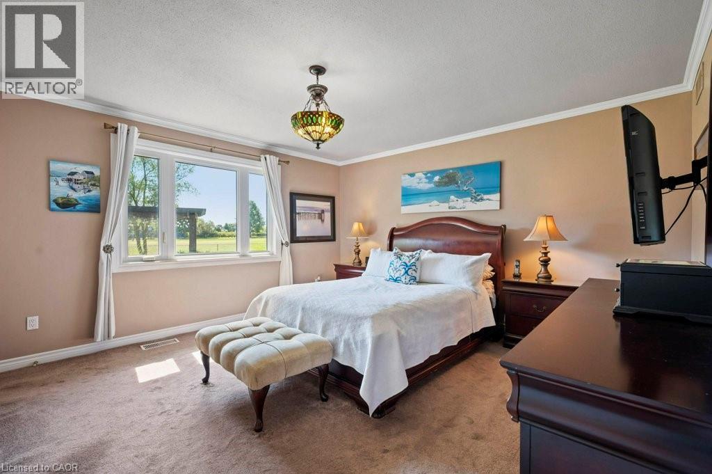 Carpeted bedroom with ornamental molding and baseboards - 3 Meadowbrook Court, St. George, ON - Indoor Photo Showing Bedroom