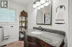 Full bath featuring vanity and a chandelier -