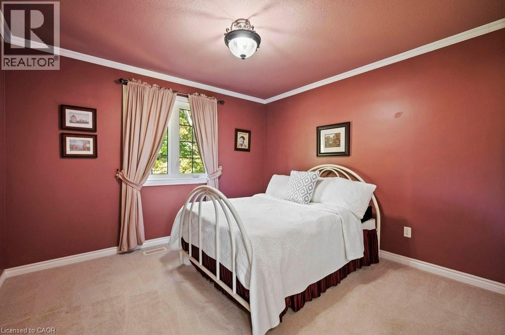 Bedroom with crown molding, light carpet, and a textured ceiling - 3 Meadowbrook Court, St. George, ON - Indoor Photo Showing Bedroom