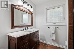Bathroom featuring vanity and dark tile patterned floors -
