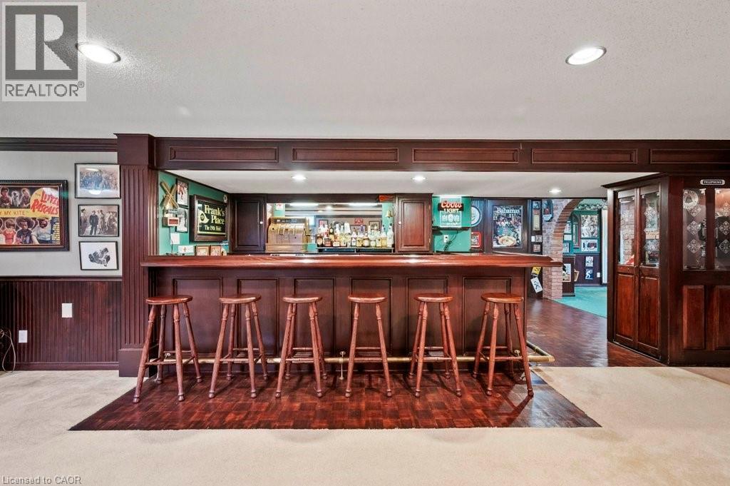 Indoor dry bar with wood walls, recessed lighting, dark carpet, ornamental molding, and a textured ceiling - 3 Meadowbrook Court, St. George, ON - Indoor Photo Showing Other Room