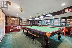 Rec room featuring carpet, a textured ceiling, wallpapered walls, billiards, and recessed lighting -