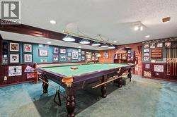 Game room with carpet floors, a textured ceiling, arched walkways, pool table, and recessed lighting -
