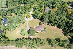 Aerial view of property's location with a heavily wooded area -
