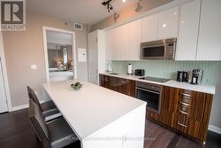 Kitchen with Hardwood & Floor-to-Ceiling Windows -