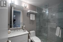 Bathroom with Marble and Glass Shower -