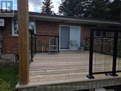 large back deck with stylish glass railing -