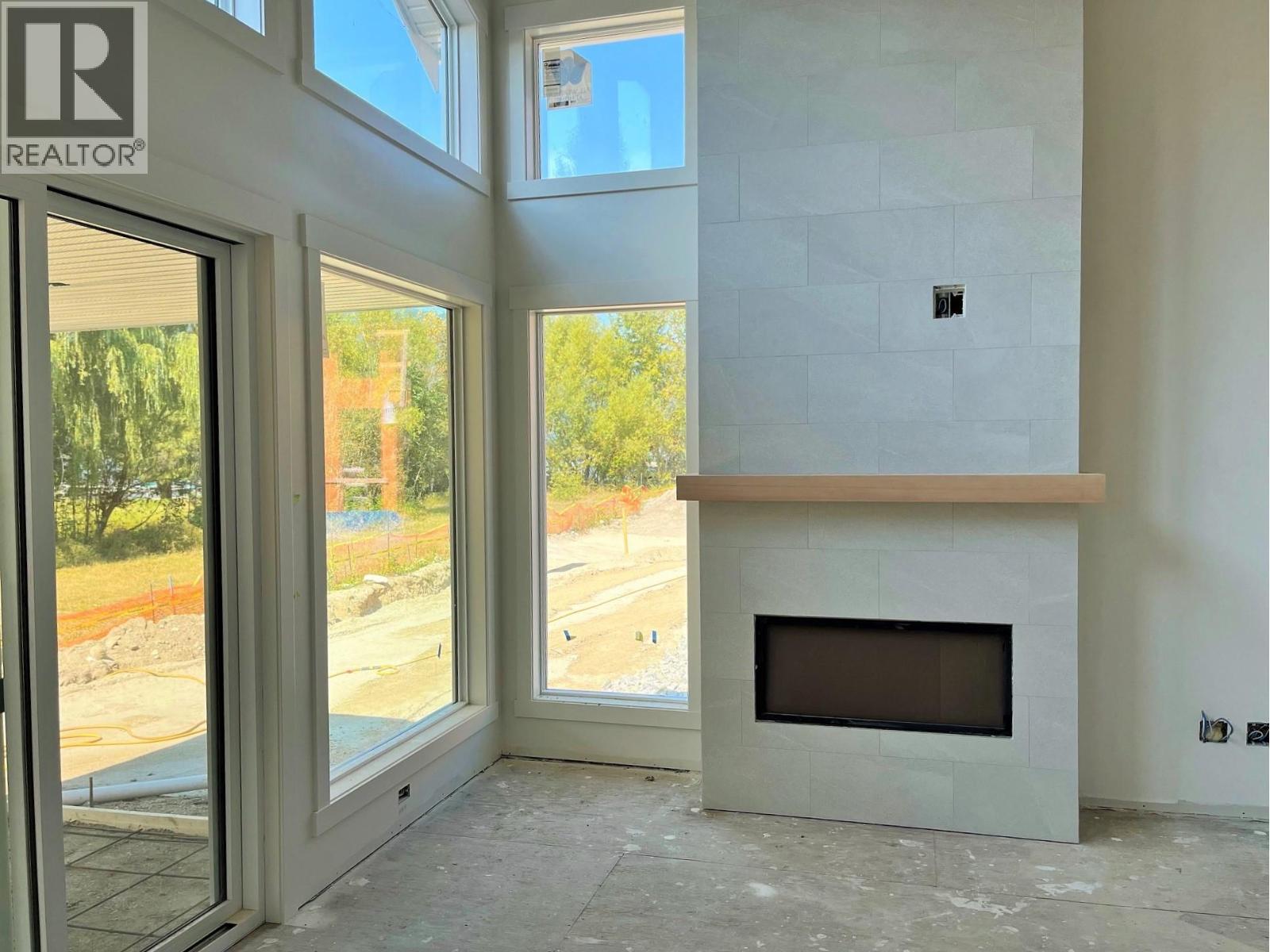 Photo for likeness reference (Unit 3) Some Upgraded Features Included - 8200 97A Highway Unit# 8, Mara, BC - Indoor With Fireplace