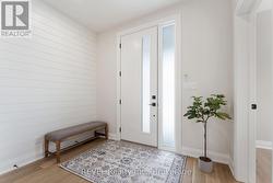 Spacious foyer with shiplap detail -