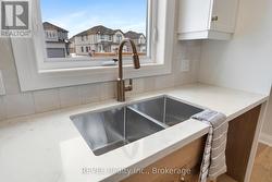 great view from sink to the side yard and street -
