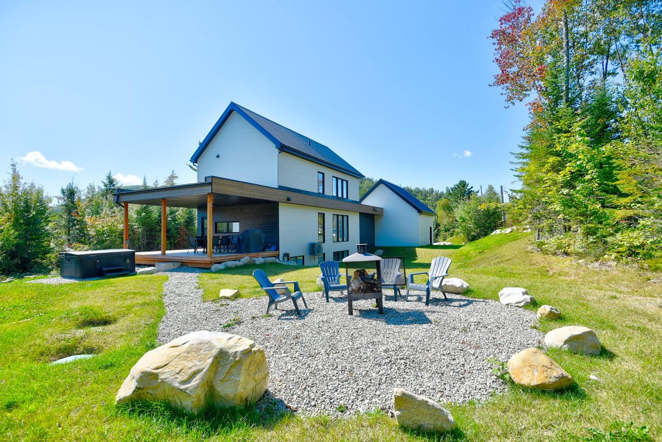 Back facade - 551 Ch. Du Quartier-Du-Cerf, Saint-Côme, QC - Outdoor With Deck Patio Veranda With Backyard