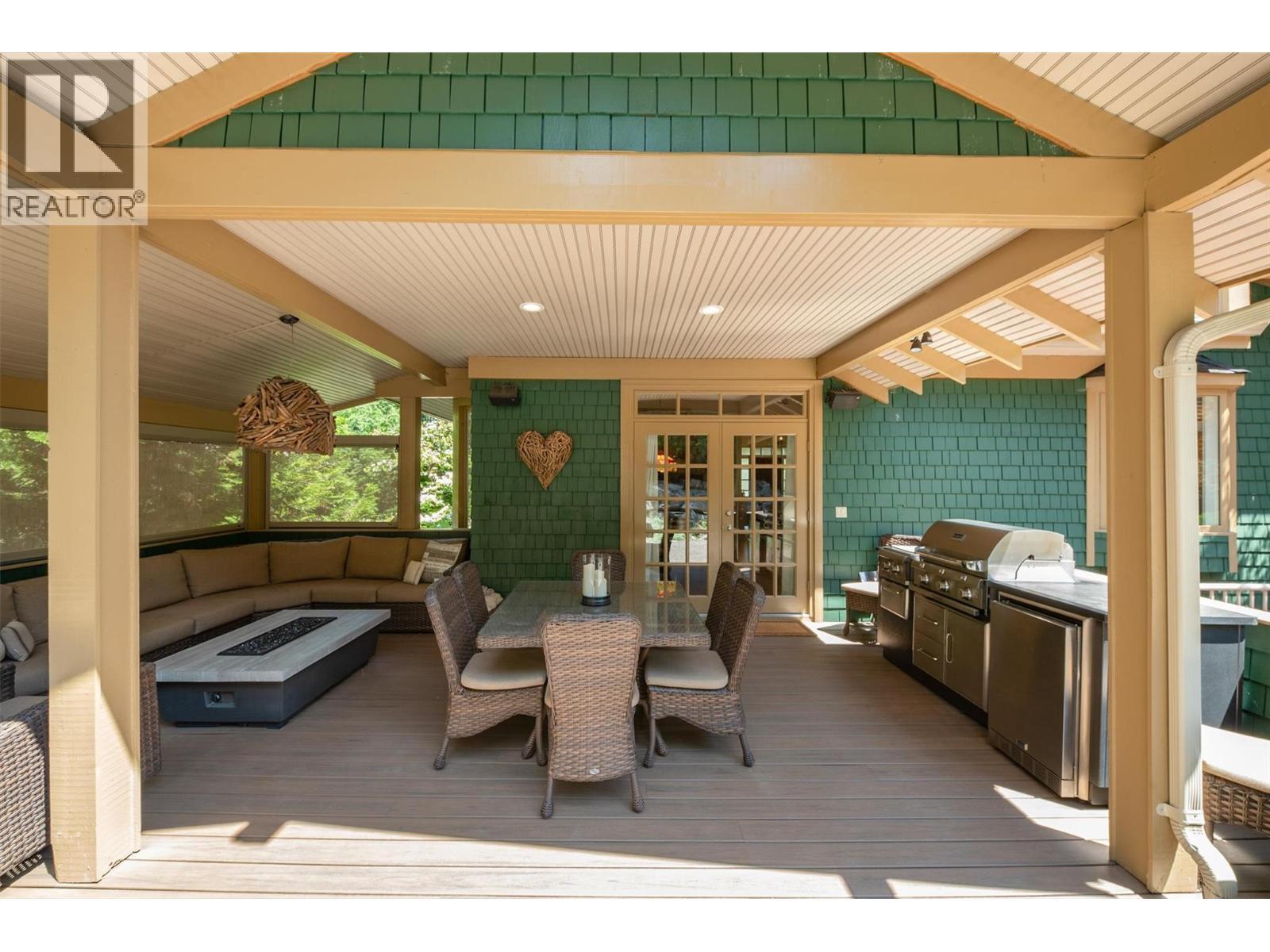 Enjoy the covered and screened porch with BBQ kitchen - 5127 Luckett Court, Kelowna, BC - Outdoor With Deck Patio Veranda With Exterior