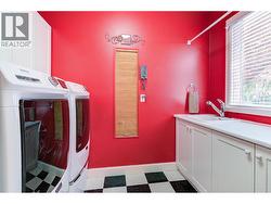 Laundry room with sink located off back mud room area -
