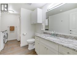 4 piece bathroom with tub/shower combo and side by side BOSCH washer and dryer -