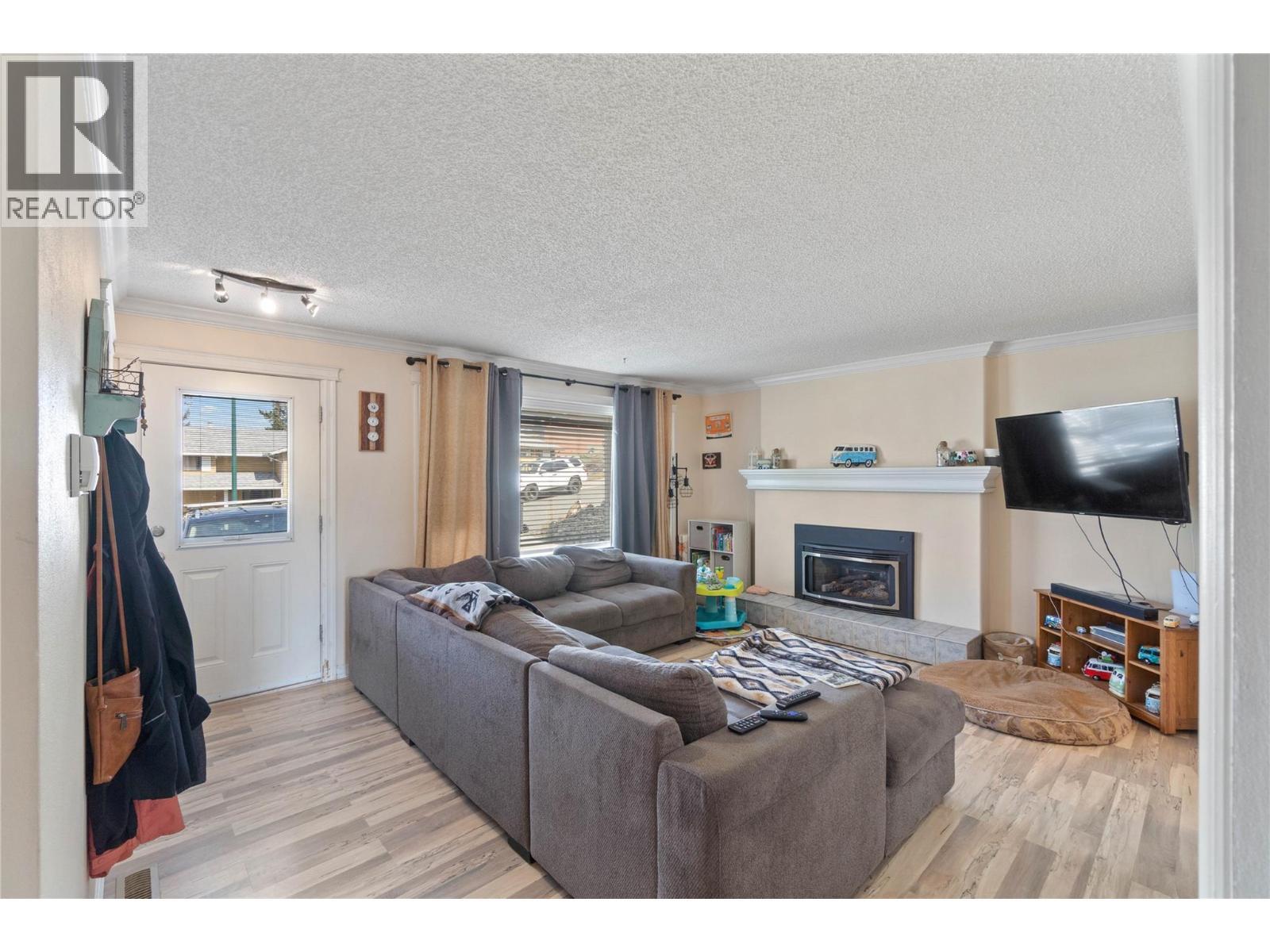 254 Alder Drive, Logan Lake, BC - Indoor Photo Showing Living Room With Fireplace