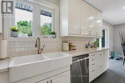 Subway tile backsplash. Window overlooks backyard -