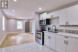 Quartz countertops in kitchen. -