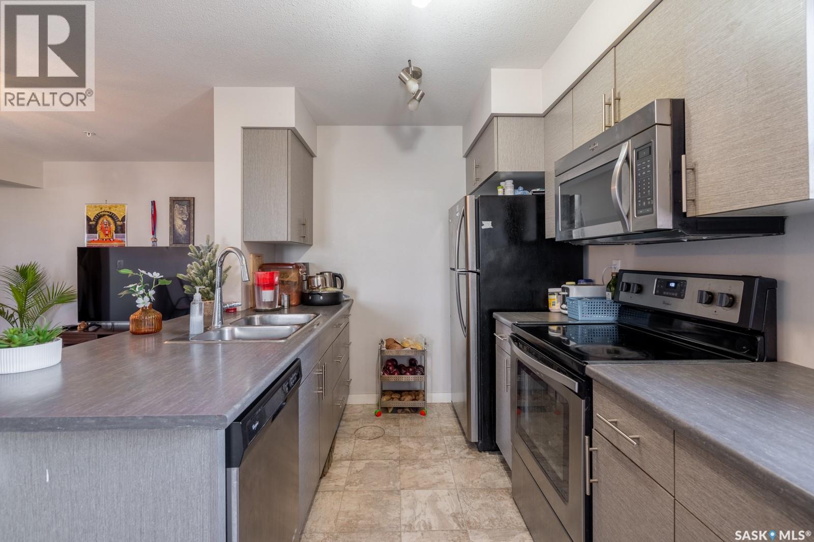 2320 5500 Mitchinson Way, Regina, SK - Indoor Photo Showing Kitchen With Stainless Steel Kitchen With Double Sink